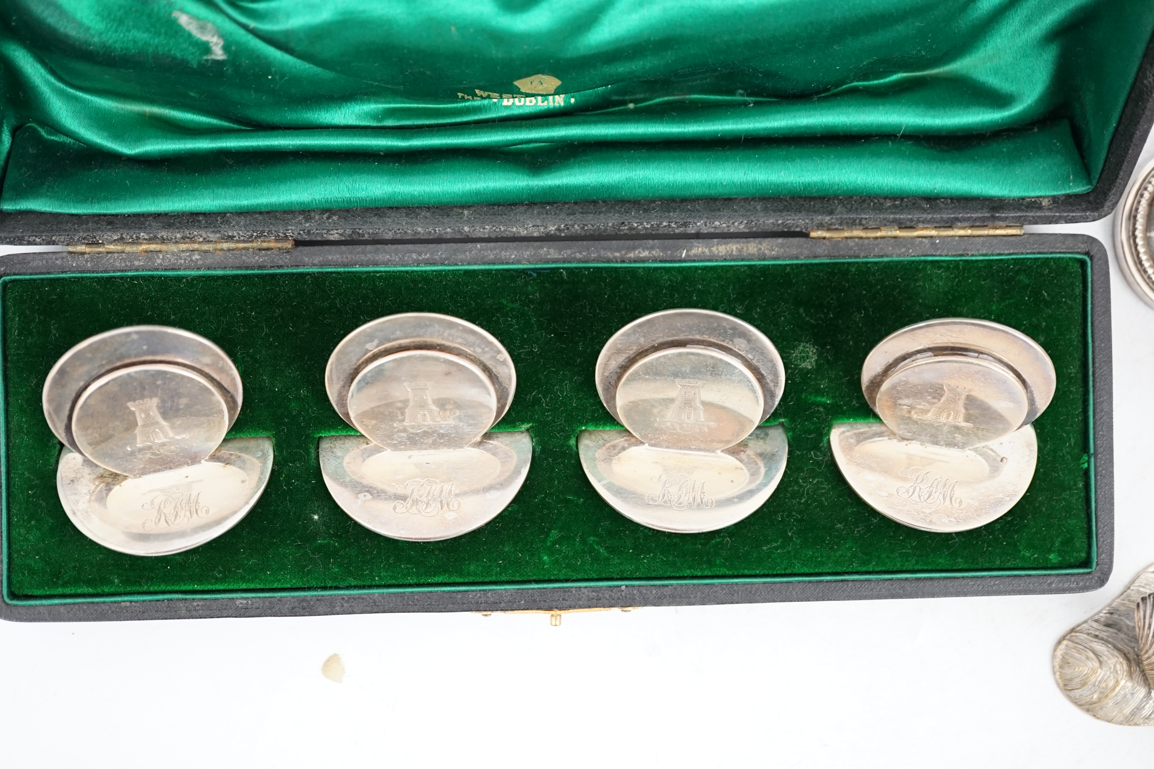 A cased set of four silver menu holders, engraved with castle crest, Sampson Mordan & Co, Chester, 1904, height 37mm, together with eight plated menu holders